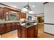 Beautiful kitchen with dark wood cabinets, granite countertops, and stainless steel appliances at 3525 Stone Cliff Way, Woodstock, GA 30189