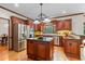 Open kitchen featuring stainless steel appliances, kitchen island and view to dining area at 3525 Stone Cliff Way, Woodstock, GA 30189