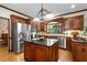 Gourmet kitchen with cherry cabinets, stainless steel appliances, granite countertops, and center island at 3525 Stone Cliff Way, Woodstock, GA 30189