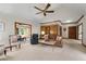 Spacious living room with a vaulted ceiling, fireplace, neutral carpet, and access to sunroom at 3525 Stone Cliff Way, Woodstock, GA 30189