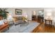 Cozy living room with hardwood floors, area rug, and view into the dining room at 3525 Stone Cliff Way, Woodstock, GA 30189