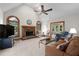 Spacious living room with a vaulted ceiling, fireplace, neutral carpet, and access to sunroom at 3525 Stone Cliff Way, Woodstock, GA 30189