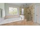 Large soaking tub and separate glass shower enclosure in the main bathroom at 3525 Stone Cliff Way, Woodstock, GA 30189