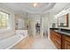 The main bathroom has a glass enclosed shower, soaking tub, and vanity with granite counters at 3525 Stone Cliff Way, Woodstock, GA 30189
