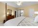Spacious main bedroom with carpet, dresser, and a sliding barn door to bath at 3525 Stone Cliff Way, Woodstock, GA 30189