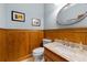 Charming powder room with wood paneling and granite countertop at 3525 Stone Cliff Way, Woodstock, GA 30189
