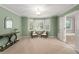Sitting room showcasing stylish decor, large bright windows, and access to the bathroom at 3525 Stone Cliff Way, Woodstock, GA 30189