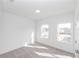 Bright bedroom with carpet, white walls, and windows overlooking the neighborhood at 4231 Millcroft Pl # 207, Buford, GA 30518