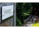 Suwanee Creek Park sign with a cyclist riding on a paved wooded path at 4231 Millcroft Pl # 207, Buford, GA 30518