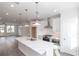 Spacious kitchen with a large island, stainless appliances, and an open view to the living area at 4231 Millcroft Pl # 207, Buford, GA 30518