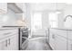 Close-up of modern kitchen with stainless steel appliances and bright, natural lighting at 4231 Millcroft Pl # 207, Buford, GA 30518
