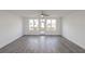 Bright living room featuring hardwood floors, large windows, and a ceiling fan at 4231 Millcroft Pl # 207, Buford, GA 30518