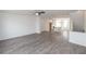 Open floor plan with hardwood floors seamlessly connecting the living room and kitchen area at 4231 Millcroft Pl # 207, Buford, GA 30518
