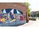 Large mural of jazz musicians on the exterior of a brick building with a flower planter at 4231 Millcroft Pl # 207, Buford, GA 30518