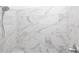 Close-up of the shower with gray-veined, white marble-look tile at 4231 Millcroft Pl # 207, Buford, GA 30518