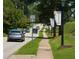 Neighborhood street view with cars, sidewalks, and Suwanee banners on the lampposts at 4231 Millcroft Pl # 207, Buford, GA 30518