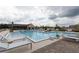 Community swimming pool is surrounded by lounge chairs and a well-manicured outdoor common area at 4231 Millcroft Pl # 207, Buford, GA 30518