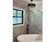 Modern bathroom with a freestanding tub and marble accent wall at 6716 Browns Mill Rd, Lithonia, GA 30038