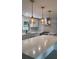 Bright kitchen with stainless steel appliances, white cabinets, and stylish pendant lighting at 6716 Browns Mill Rd, Lithonia, GA 30038