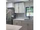 Modern kitchen featuring white cabinets, stainless steel appliances, and a sink near the window at 6716 Browns Mill Rd, Lithonia, GA 30038