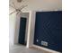 Contemporary living room with an navy accent wall and modern lighting fixture at 6716 Browns Mill Rd, Lithonia, GA 30038