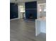 Open living room featuring hardwood floors, a blue accent wall, and plenty of natural light at 6716 Browns Mill Rd, Lithonia, GA 30038