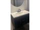 Modern vanity with a black faucet and a round mirror at 6716 Browns Mill Rd, Lithonia, GA 30038