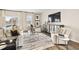 Elegant living room with hardwood floors, modern decor, and plenty of natural light at 1240 Arnhem Dr, Hampton, GA 30228