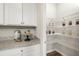 Walk-in pantry with ample shelving and granite countertop at 1240 Arnhem Dr, Hampton, GA 30228