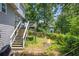 View of the backyard with a fire pit, deck, and stairs leading to the upper level at 2196 Kildare Nw Way, Kennesaw, GA 30152