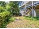 Home's backyard featuring a fire pit and wooden fence with stairs leading to the deck at 2196 Kildare Nw Way, Kennesaw, GA 30152