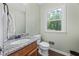 Cozy bathroom with granite countertop, wooden vanity, and a window view at 2196 Kildare Nw Way, Kennesaw, GA 30152