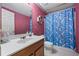 Bathroom with colorful shower curtain, single sink vanity, and standard fixtures at 2196 Kildare Nw Way, Kennesaw, GA 30152