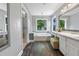 Bright bathroom with a large soaking tub, dual windows, and updated vanity at 2196 Kildare Nw Way, Kennesaw, GA 30152