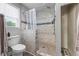 Tiled walk-in shower and toilet in a bathroom with a bright window at 2196 Kildare Nw Way, Kennesaw, GA 30152