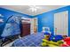 Blue bedroom with ceiling fan, dresser and decor, and window views at 2196 Kildare Nw Way, Kennesaw, GA 30152