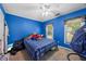 Brightly painted blue bedroom with ceiling fan and windows at 2196 Kildare Nw Way, Kennesaw, GA 30152