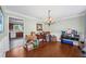 Traditional dining room with hardwood floors, classic chandelier, and view into the kitchen at 2196 Kildare Nw Way, Kennesaw, GA 30152