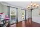 Dining area featuring hardwood floors, traditional chandelier, and bright windows at 2196 Kildare Nw Way, Kennesaw, GA 30152