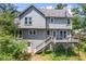 View of the home's two-story exterior with gray siding, windows, and a backyard deck with stairs at 2196 Kildare Nw Way, Kennesaw, GA 30152