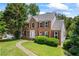 Beautiful brick home featuring traditional architecture and a lush green lawn at 2196 Kildare Nw Way, Kennesaw, GA 30152