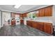 Spacious kitchen area with wood cabinets, white appliances, and wood look tile at 2196 Kildare Nw Way, Kennesaw, GA 30152