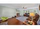Living room with hardwood floors, a ceiling fan, a fireplace, and a television above the mantel at 2196 Kildare Nw Way, Kennesaw, GA 30152