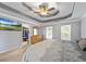 Main bedroom featuring carpet flooring, tray ceilings, and open walk-in closet at 2196 Kildare Nw Way, Kennesaw, GA 30152