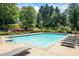 Large community swimming pool surrounded by lounge chairs and lush landscaping at 2196 Kildare Nw Way, Kennesaw, GA 30152