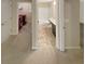 Hallway with view to bathroom with shower/tub combo, laundry room with red washer and dryer at 265 Edinburgh Ln, Woodstock, GA 30188