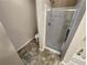 Bathroom featuring a glass-enclosed shower, bathtub, toilet, and tile flooring at 265 Edinburgh Ln, Woodstock, GA 30188