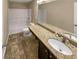 Well-lit bathroom with granite countertop, white toilet and shower-tub combo at 265 Edinburgh Ln, Woodstock, GA 30188