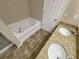 Well-appointed bathroom featuring double sinks, granite countertops, bathtub, and tile flooring at 265 Edinburgh Ln, Woodstock, GA 30188