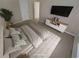 This staged bedroom features modern decor, a large window, and console table at 265 Edinburgh Ln, Woodstock, GA 30188